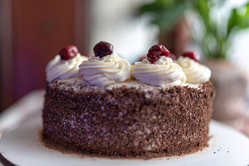 Black forest cherry cake close-up. Sponge cake with chocolate and cherries.