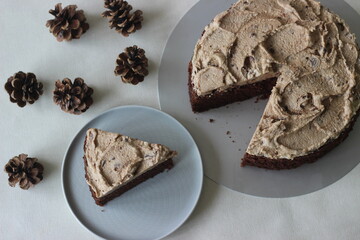 Sliced chocolate cake with vanilla butter icing mixed with chocolate as the topping