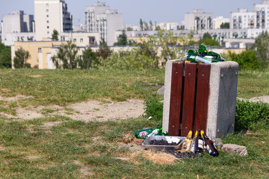 Overflowing Trash Can With The City Background