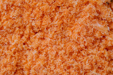 Shredded fresh carrots after juicer, close up, top view