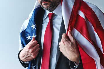 Proud patriotic american businessman wearing a US flag as a cape