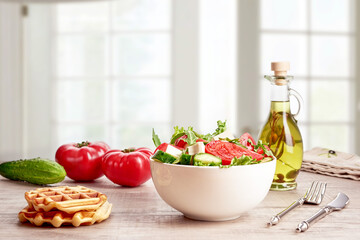 Healthy vegetable salad of fresh tomatoes, cucumbers, arugula, lettuce on a plate. Diet menu