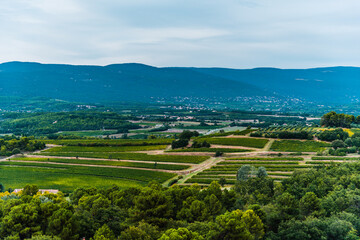 Fototapeta na wymiar South France agriculture landscape view, green fields in a valley and hills of Roussillon, Provence