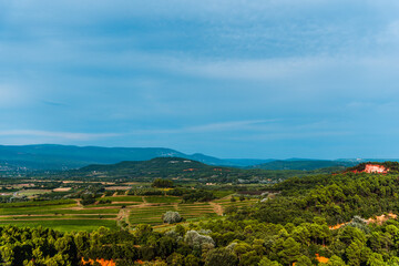 South France agriculture landscape view, green fields in a valley and hills of Roussillon, Provence