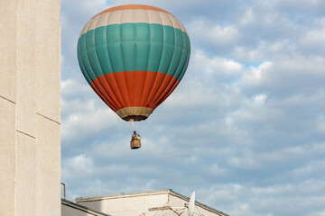 hot air balloon near the wall of the building