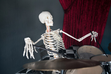 Skeleton playing drums in the studio