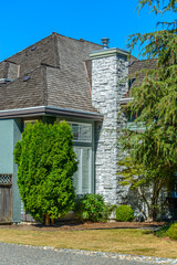A perfect neighborhood. Houses in suburb at Fall in the north America. Fragment of a luxury house with nice window.