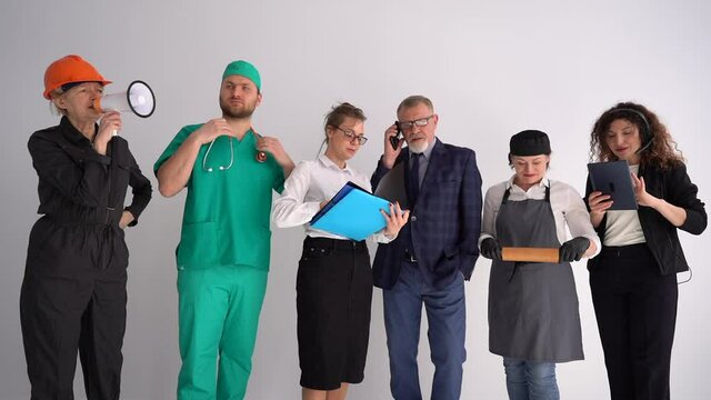 Six people in uniforms of different professions. Labor day concept. Various professions and occupations, builder, doctor, secretary, lawyer, cook, consultant
