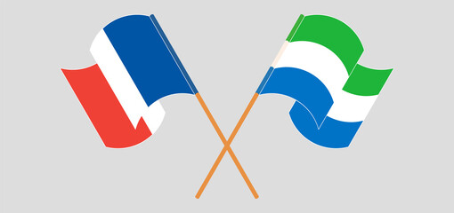 Crossed and waving flags of France and Sierra Leone