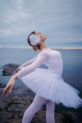 Ballerina girl in ballet dress dancing by the lake © Alex Barera