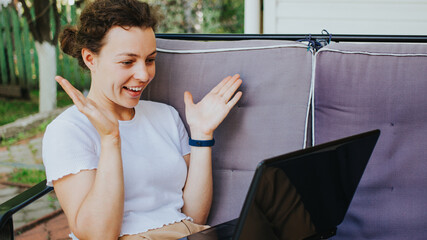 Excited young woman surprised by good unbelievable news, looking at laptop feeling amazed, sitting...