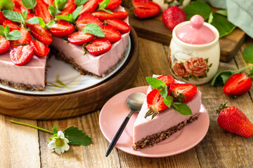 Summer diet dessert without baking Gluten-free, birthday menus. Strawberry cheesecake on a granola with fresh strawberries on a on rustic table.