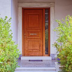 corridor between green plants to elegant house wooden door, Athens Greece