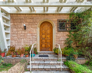 Fototapeta na wymiar elegant house front stone covered steps and wooden door, Athens Greece