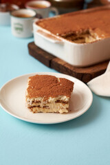 Tiramisu and coffee on a blue background.