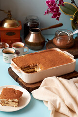 Tiramisu and coffee on a blue background.