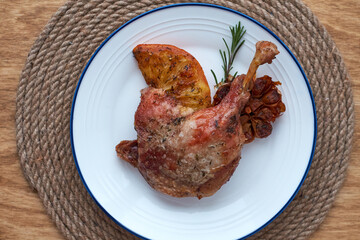 Duck confit. Wooden background, top view.