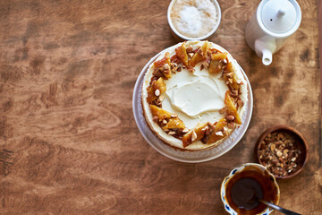 Banana cake with caramel. Wooden background, top view.