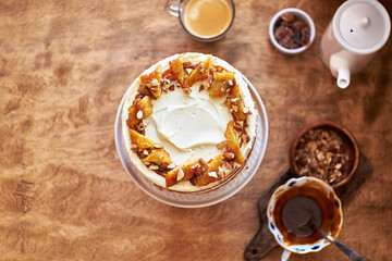 Banana cake with caramel. Wooden background, top view.