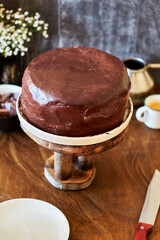 Dark chocolate cake. Side view. Wooden background.