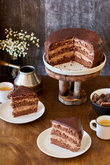Dark chocolate cake. Side view. Wooden background.