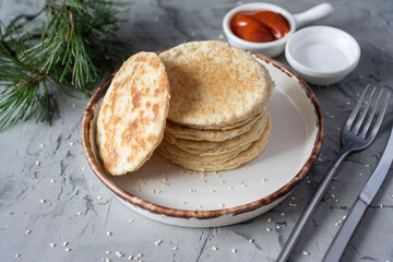 Vegetarian breakfast: delicious rice cakes on a white plate and ketchup on a gray background