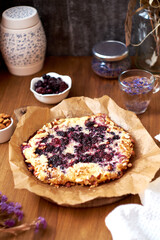 Blueberry, frangipane galette. Side view. Wooden background.