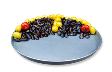 Plate of stuffed mussels with lemons and tomatoes against white background. Turkish traditional street food is Midye Dolma