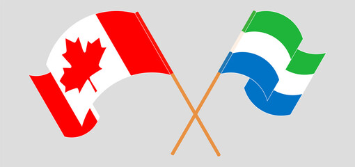 Crossed and waving flags of Canada and Sierra Leone