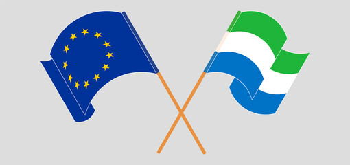 Crossed and waving flags of the European Union and Sierra Leone
