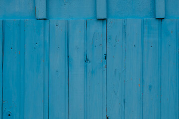 Old boards with cracks in bright blue.