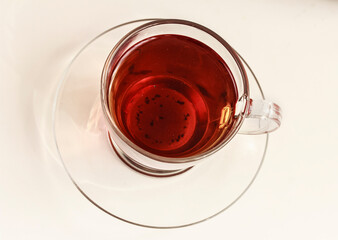 Top view of  transparent glass cup of black tea or rooibos tea white background. Closeup. Tea background. Stock photo, copy space