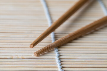 Wood Chopsticks on Bamboo Mat