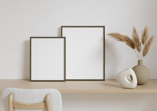 Double 8x10 Vertical Black Frame mockup on a wooden desk with dry plant in vase. 3D Rendering