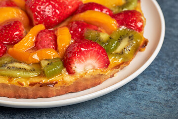 Close-up of a delicious fresh fruit tart made of temoprada and cream.