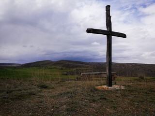 Fototapeta na wymiar Christian cross against the sky over the mountains