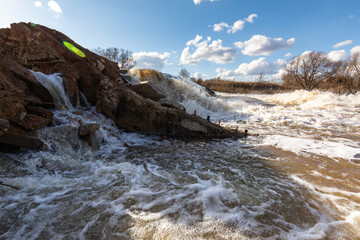 Powerful spring stream of water. Spring flood. Russian nature in spring. The destructive power of...