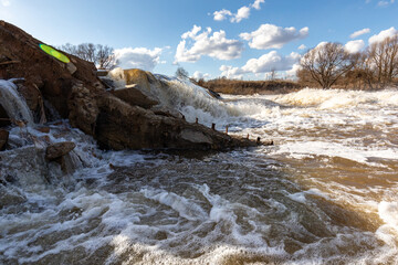 Powerful spring stream of water. Spring flood. Russian nature in spring. The destructive power of...