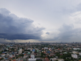Rain clouds are falling far in the city.