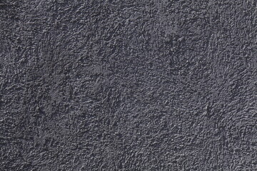 Relief surface. Grey wall, texture, background. Plastered building wall, painted with water-based grey paint. Decorated surface with blurry chaotic pattern. Embossed patterns. Abstract exterior