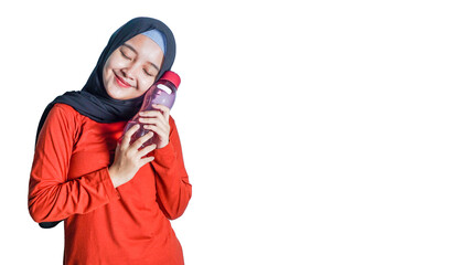 asian woman with hijab holding a water bottle.