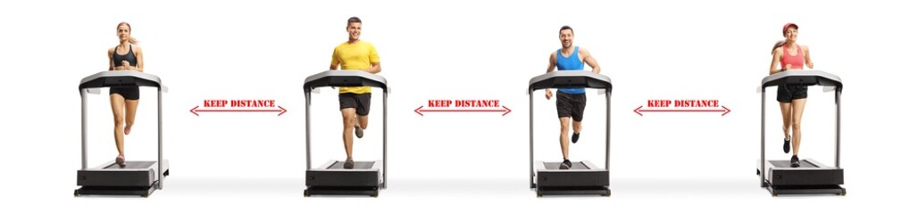 People running on treadmills with sign keep distance