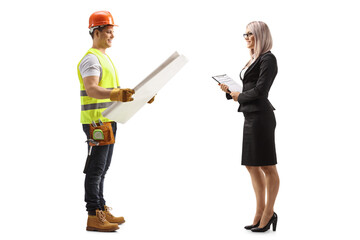 Full length profile shot of a construction worker holding a blueprint and talking to a businesswoman