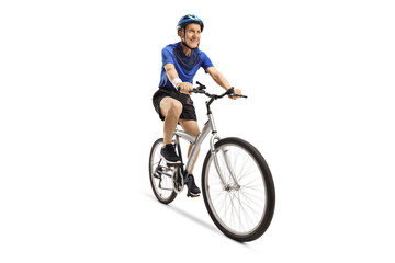 Obraz premium Elderly male cyclist riding a bicycle with a helmet
