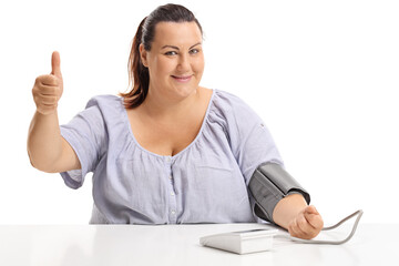 Corpulent young woman checking blood pressure