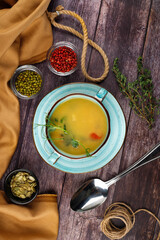 Fresh fish soup with ingredients and spices for cooking. Wooden background.