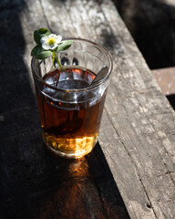 Cup of tea and wild strawberries on a wooden background