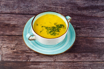Carrot soup on a wooden table