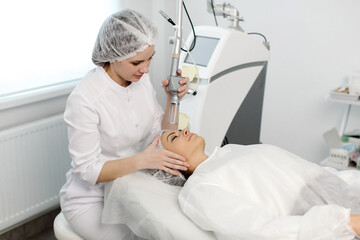 Cosmetology. Closeup Of Female Face having facial treatment in beauty salon. Cosmetic procedures in...