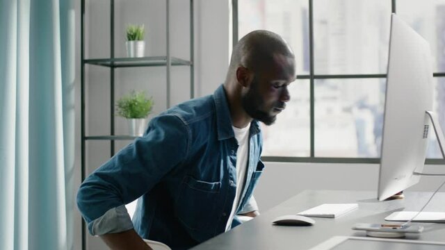 African freelancer works on project on contemporary computer